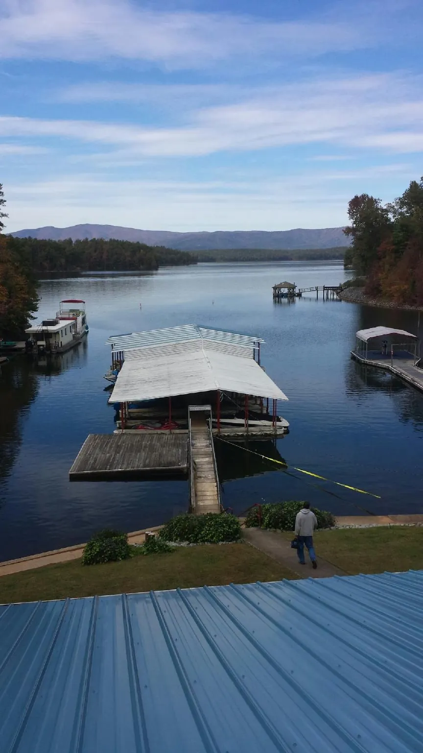 View across a lake from a newly installed blue metal roof in Chelmsford